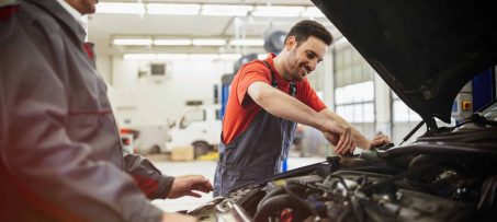 Car mechanics working on car maintenance