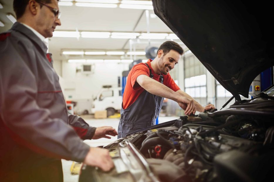 Car mechanics working on car maintenance