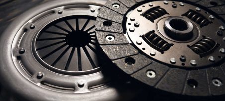 new car clutch kit on a black wooden background. Close up