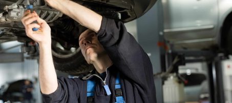 Auto mechanic working on car engine in mechanics garage. Repair service. authentic. Wrench, Spanner.