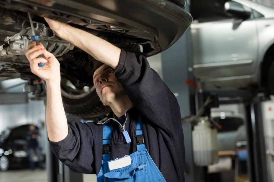 Auto mechanic working on car engine in mechanics garage. Repair service. authentic. Wrench, Spanner.